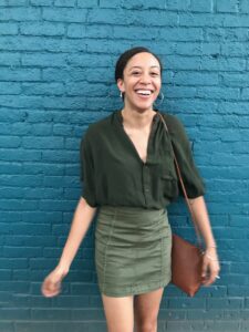 woman posing against wall