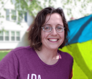 white woman with glasses and curly hair