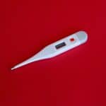 thermometer sitting on a red backdrop