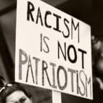 photo of protest sign racism is not patriotism