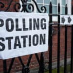 black letters that spell out polling station
